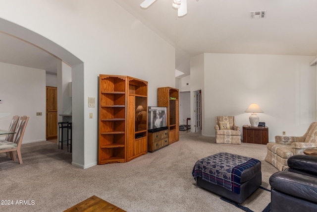 living room featuring carpet flooring, ceiling fan, and high vaulted ceiling