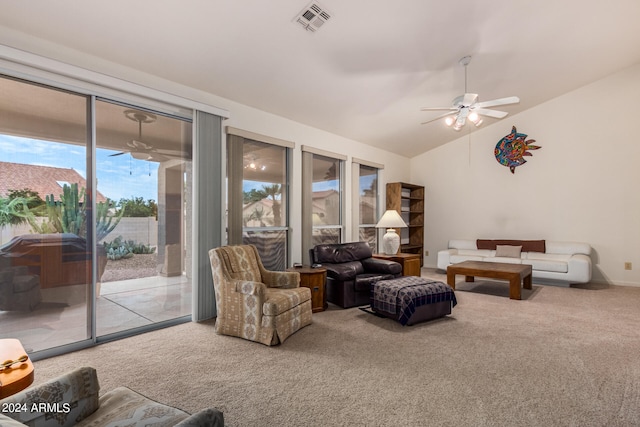 living room featuring lofted ceiling, ceiling fan, and carpet