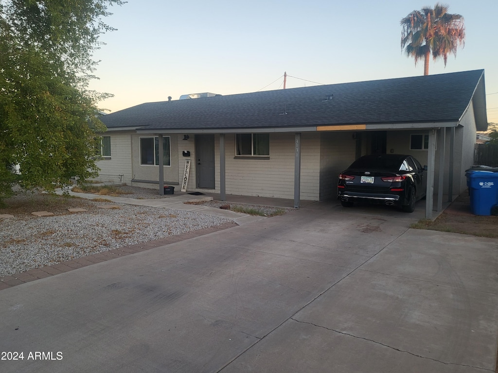 ranch-style home featuring a carport