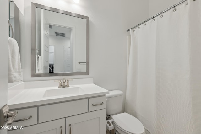 full bathroom featuring toilet, visible vents, and vanity