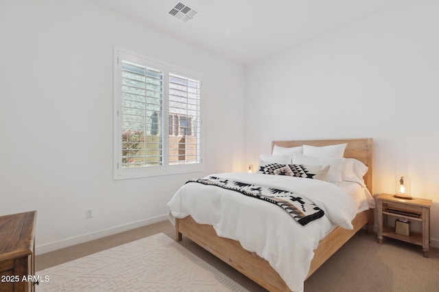 bedroom with baseboards, visible vents, and carpet flooring