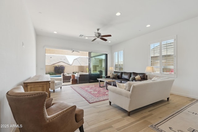 living area featuring recessed lighting, visible vents, light wood-style floors, ceiling fan, and baseboards