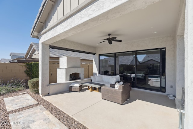 view of patio / terrace with ceiling fan, an outdoor living space with a fireplace, and fence