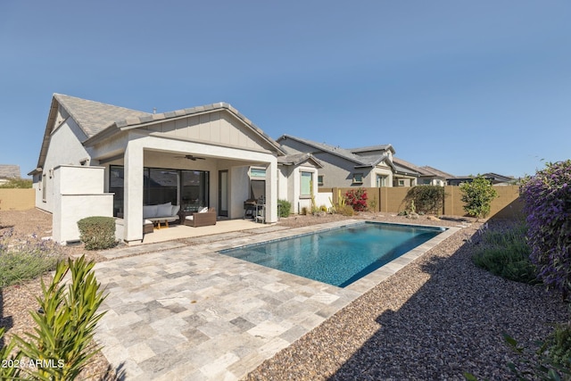 back of property with a fenced backyard, an outdoor hangout area, a ceiling fan, a fenced in pool, and a patio area