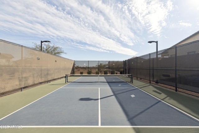 view of sport court featuring fence