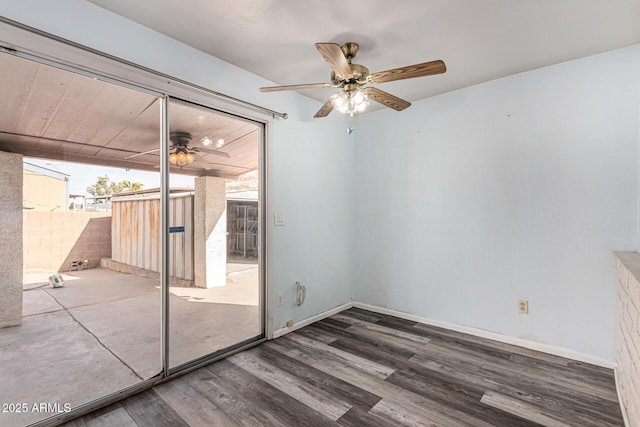 unfurnished room with baseboards, dark wood-style flooring, and ceiling fan
