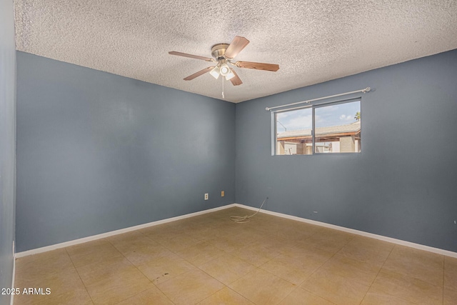 empty room featuring ceiling fan, baseboards, and a textured ceiling