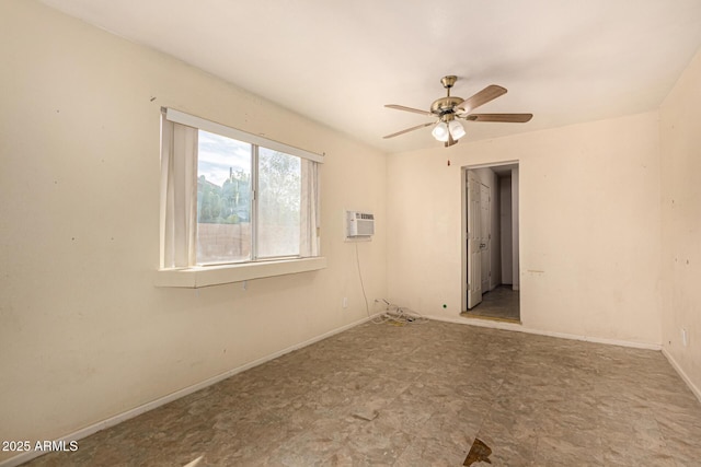 spare room with baseboards, a wall mounted air conditioner, and ceiling fan