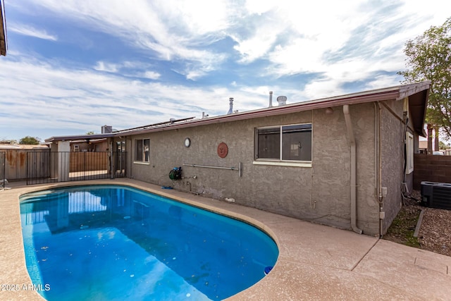 view of swimming pool with fence, a patio, cooling unit, and a fenced in pool