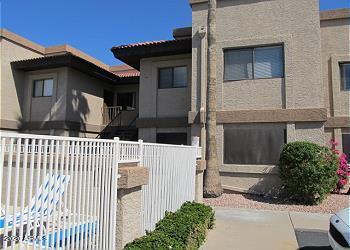 view of front of home with fence and stucco siding