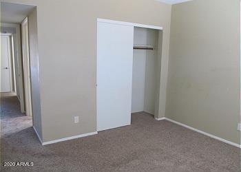 unfurnished bedroom with a closet and carpet