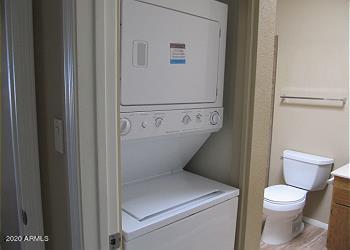 laundry area featuring laundry area and stacked washing maching and dryer