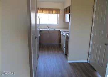 kitchen featuring dark wood-style floors, light countertops, a sink, and white range with electric stovetop