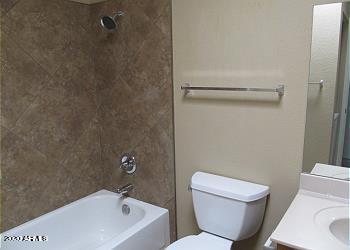 bathroom with toilet, bathtub / shower combination, and vanity