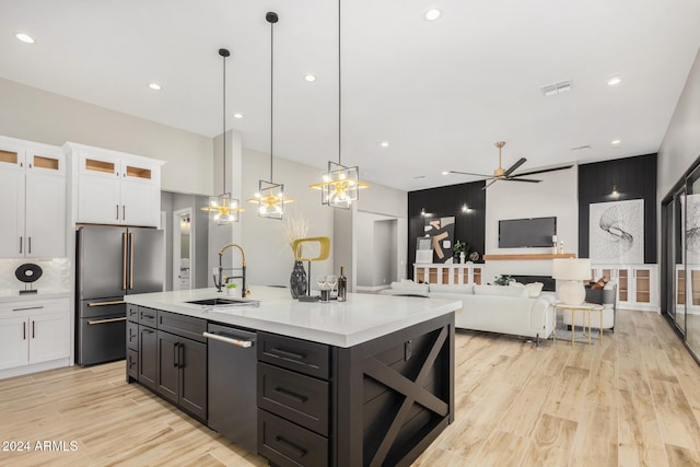 kitchen featuring ceiling fan, white cabinets, hanging light fixtures, and appliances with stainless steel finishes