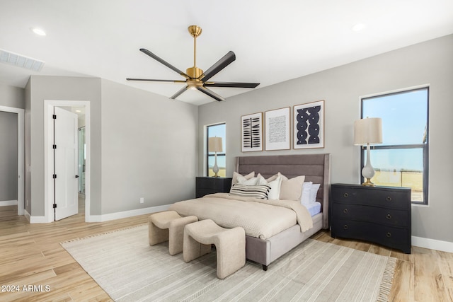 bedroom featuring multiple windows, ceiling fan, and light hardwood / wood-style floors