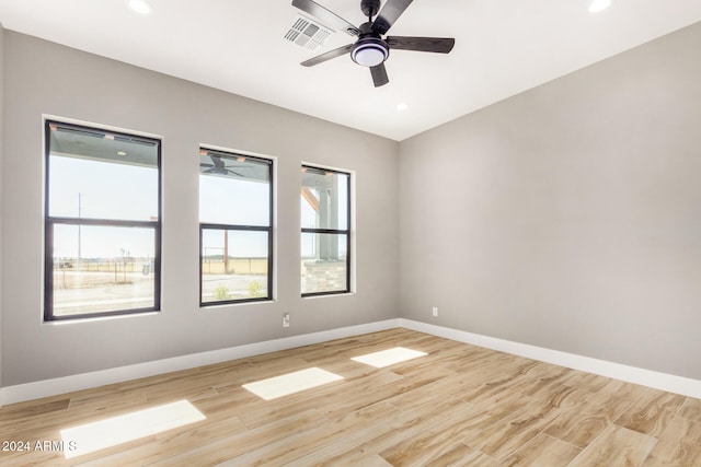 empty room featuring ceiling fan and light hardwood / wood-style flooring