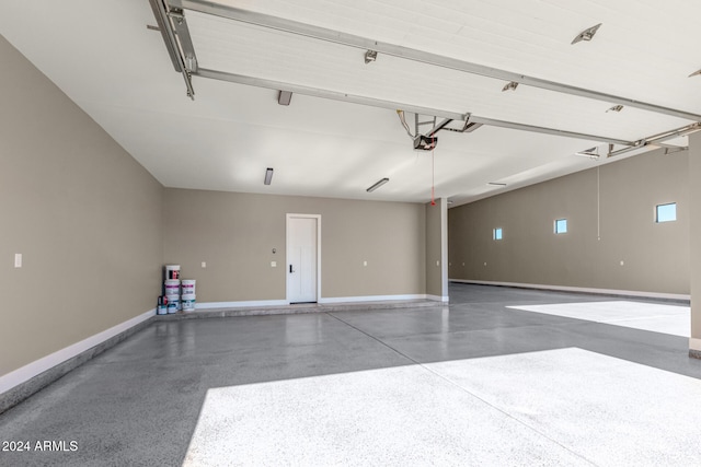 garage with a garage door opener and a carport