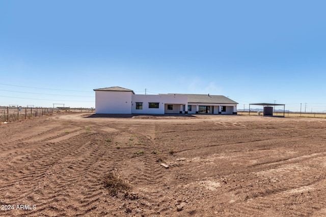 view of front facade with a rural view and a carport