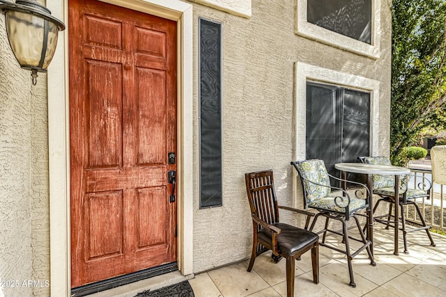 view of exterior entry with stucco siding