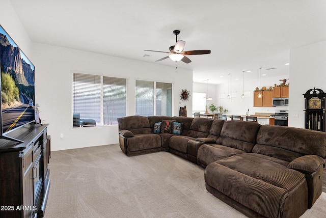 carpeted living room featuring ceiling fan