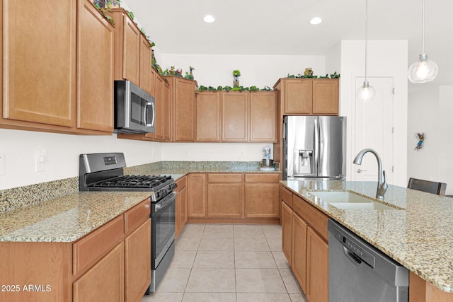 kitchen with appliances with stainless steel finishes, decorative light fixtures, sink, light tile patterned floors, and light stone countertops