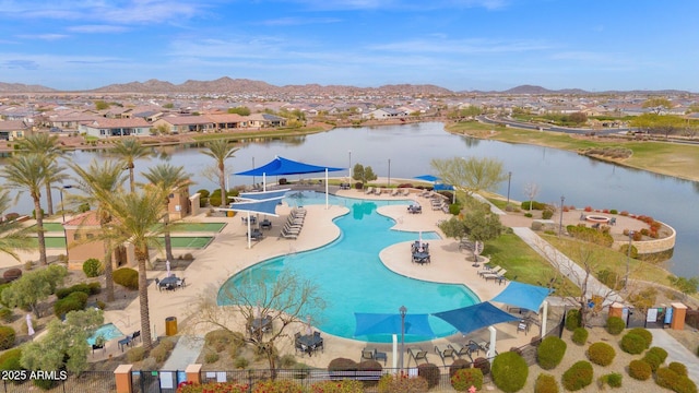 view of swimming pool featuring a water and mountain view and a patio area