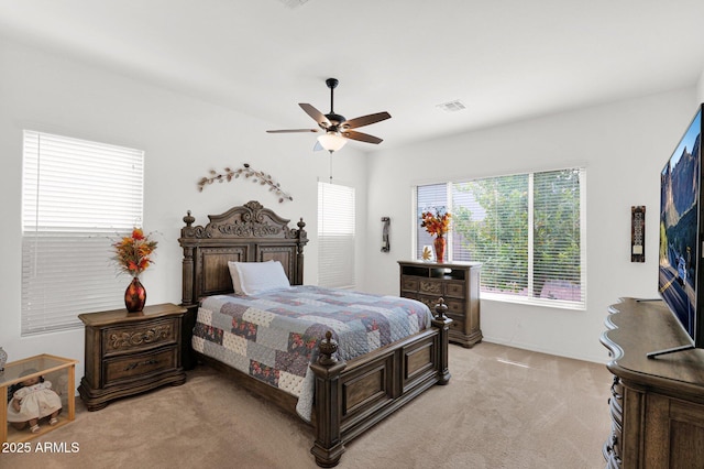 bedroom featuring ceiling fan and light carpet