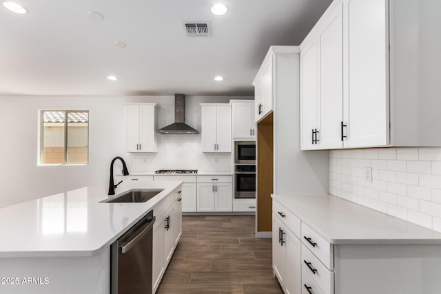 40546 W Michaels Dr, Maricopa, AZ 85138 - kitchen with wall chimney range hood, a sink, appliances with stainless steel finishes, light countertops, and recessed lighting