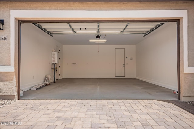 40546 W Michaels Dr, Maricopa, AZ 85138 - garage featuring a garage door opener and baseboards