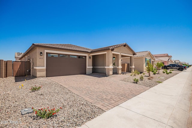 40546 W Michaels Dr, Maricopa, AZ 85138 - view of front of property with stucco siding, decorative driveway, a garage, a gate, and a tiled roof