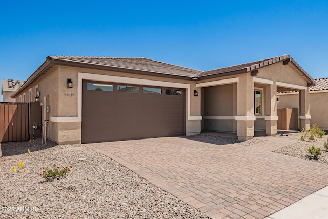 40546 W Michaels Dr, Maricopa, AZ 85138 - view of front facade featuring a garage, stucco siding, decorative driveway, and a tile roof