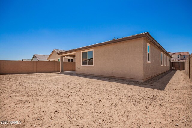 40546 W Michaels Dr, Maricopa, AZ 85138 - back of house with a fenced backyard and stucco siding