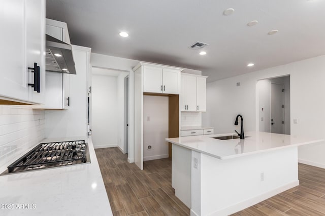 40546 W Michaels Dr, Maricopa, AZ 85138 - kitchen featuring a sink, stainless steel gas stovetop, wall chimney exhaust hood, wood finished floors, and recessed lighting
