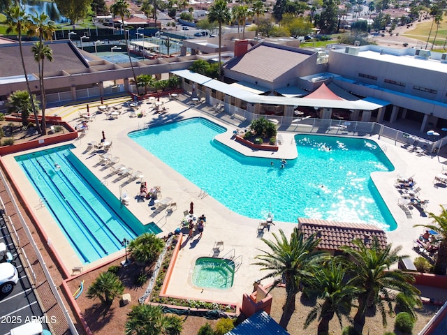 community pool featuring a community hot tub and a patio area
