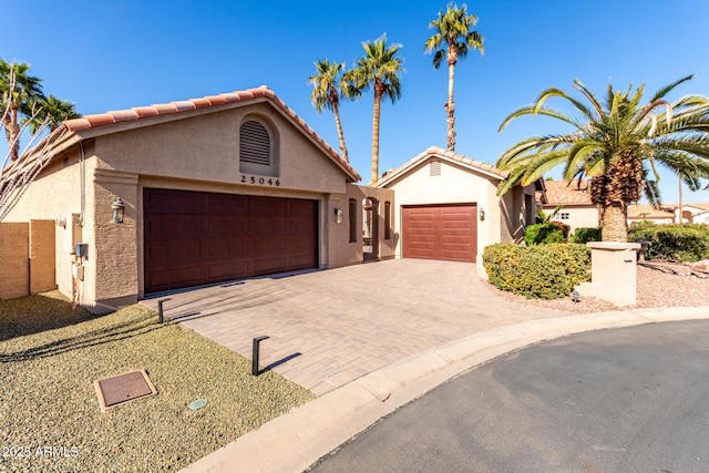 mediterranean / spanish-style home with a garage