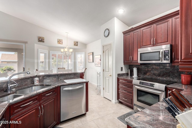 kitchen featuring sink, an inviting chandelier, backsplash, vaulted ceiling, and appliances with stainless steel finishes