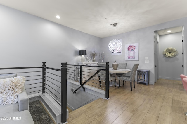 stairway featuring a chandelier, recessed lighting, and wood finished floors