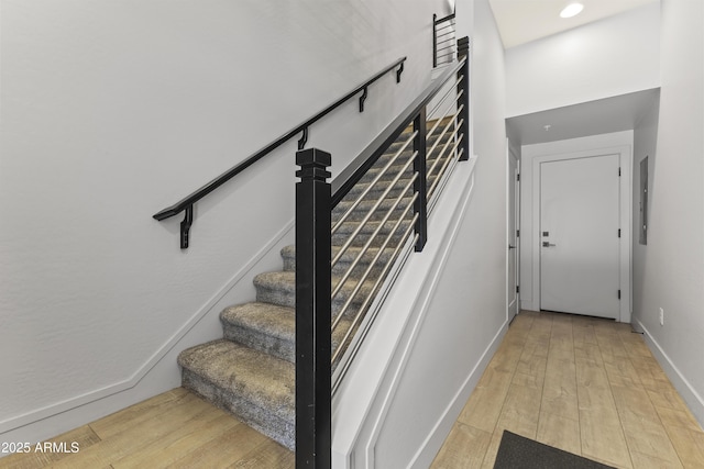 stairway with hardwood / wood-style flooring, recessed lighting, and baseboards