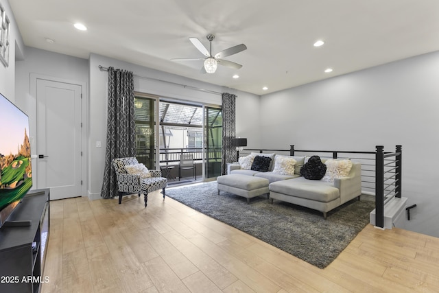 living room featuring recessed lighting, a ceiling fan, and wood finished floors