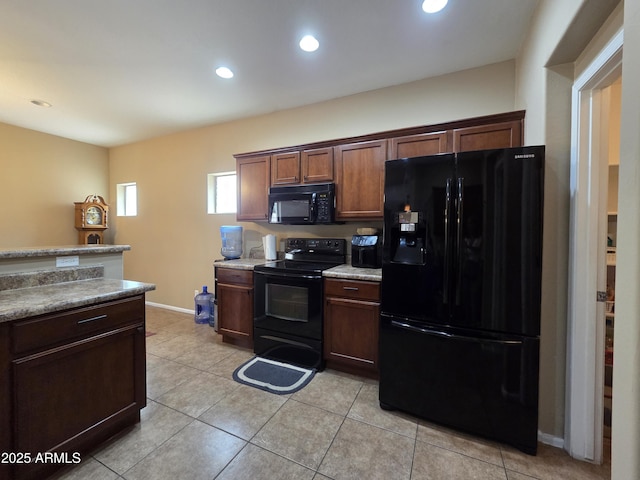 6565 E Thomas Rd Unit 1128, Scottsdale, AZ 85251 - kitchen with black appliances, light tile patterned flooring, recessed lighting, light countertops, and baseboards