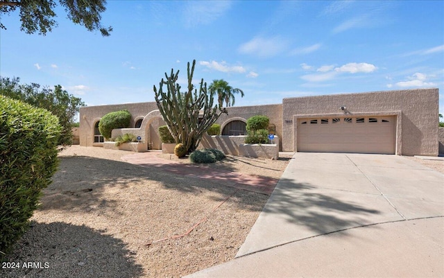 pueblo-style home with a garage