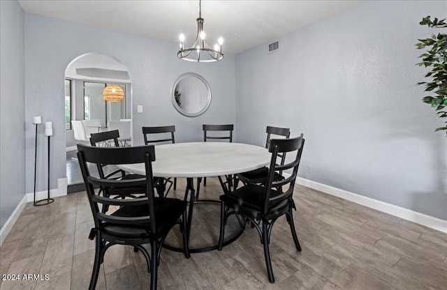 dining area with an inviting chandelier and light wood-type flooring