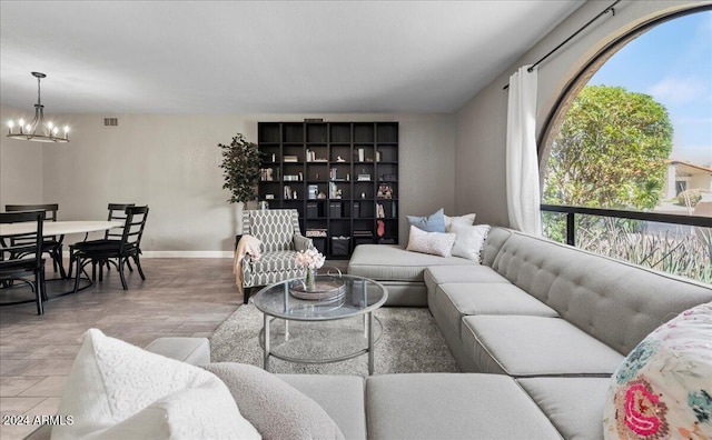 living room with a notable chandelier and light hardwood / wood-style flooring