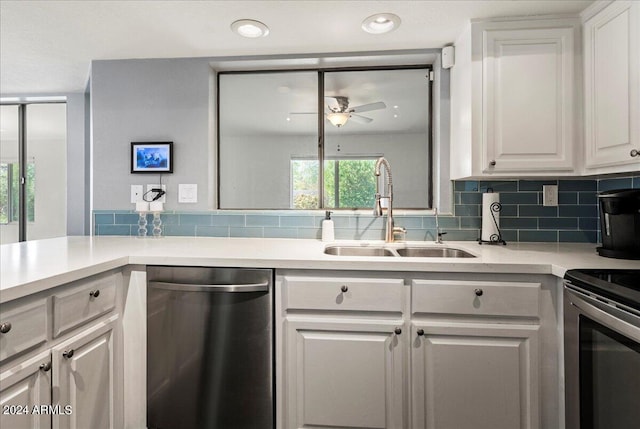 kitchen with sink, white cabinets, backsplash, appliances with stainless steel finishes, and ceiling fan