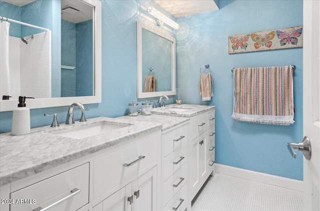 bathroom featuring tile patterned flooring, walk in shower, and vanity