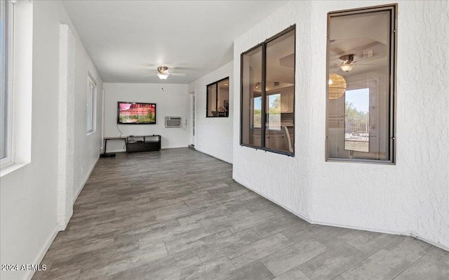 hall with hardwood / wood-style floors and a wall unit AC