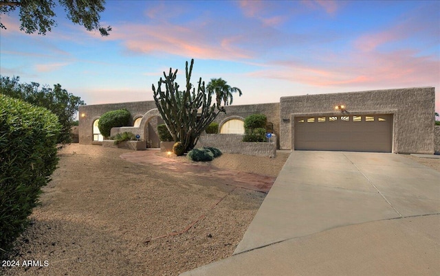 pueblo-style home featuring a garage