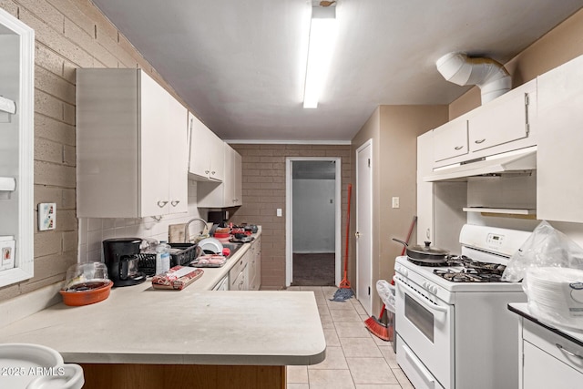 705 S Pima, Mesa, AZ 85210 - kitchen featuring white gas range, under cabinet range hood, light countertops, light tile patterned flooring, and white cabinetry
