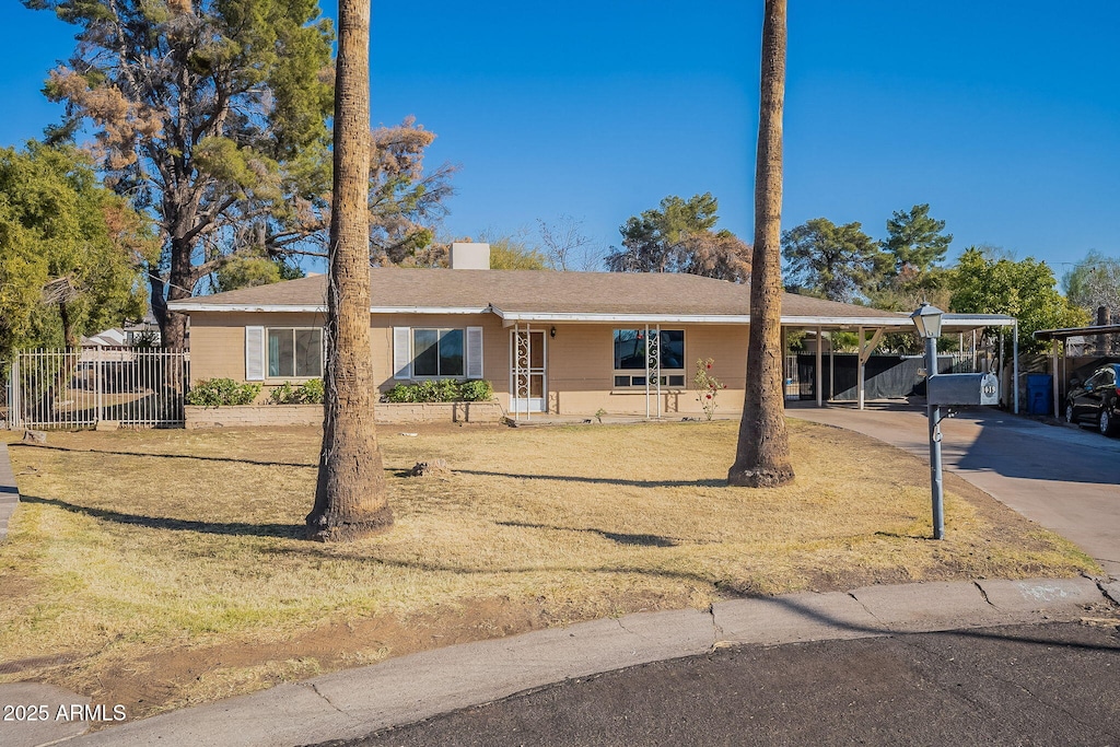 single story home with a carport and a front yard